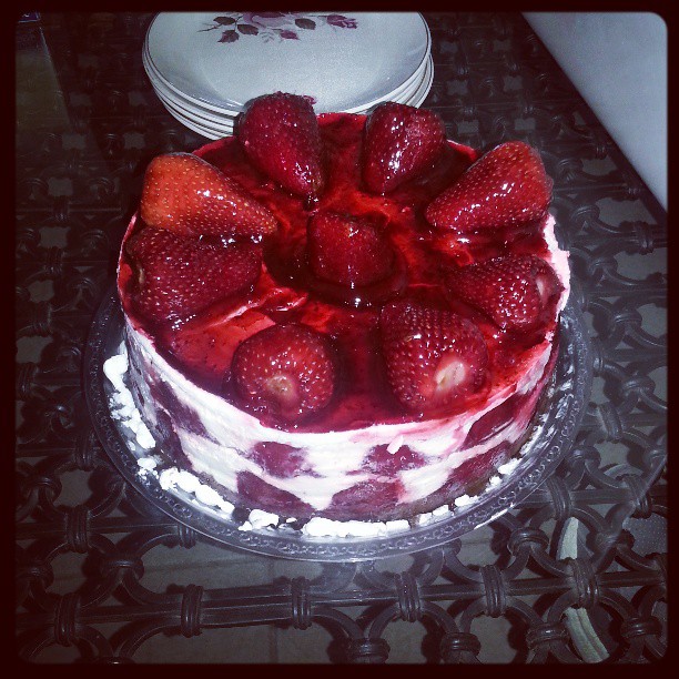 a fancy decorated cake has strawberries on it