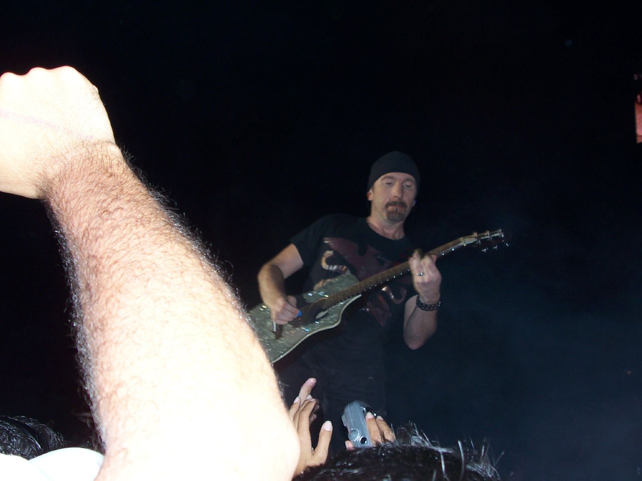 a man playing a guitar on stage during a show