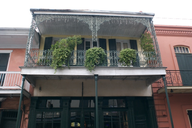 some plants and other decorations adorning the outside of an old building