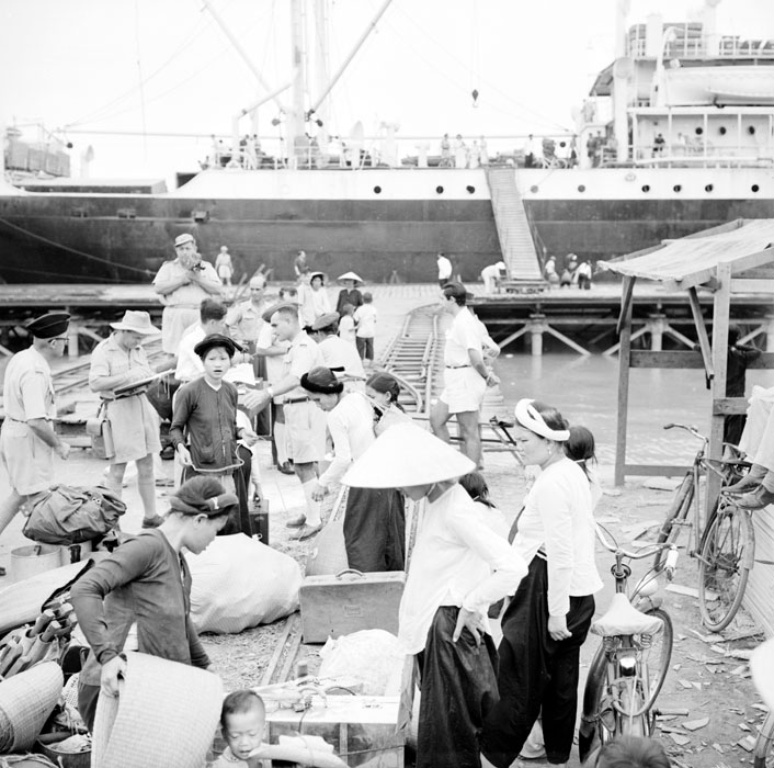 a black and white po of people on the dock