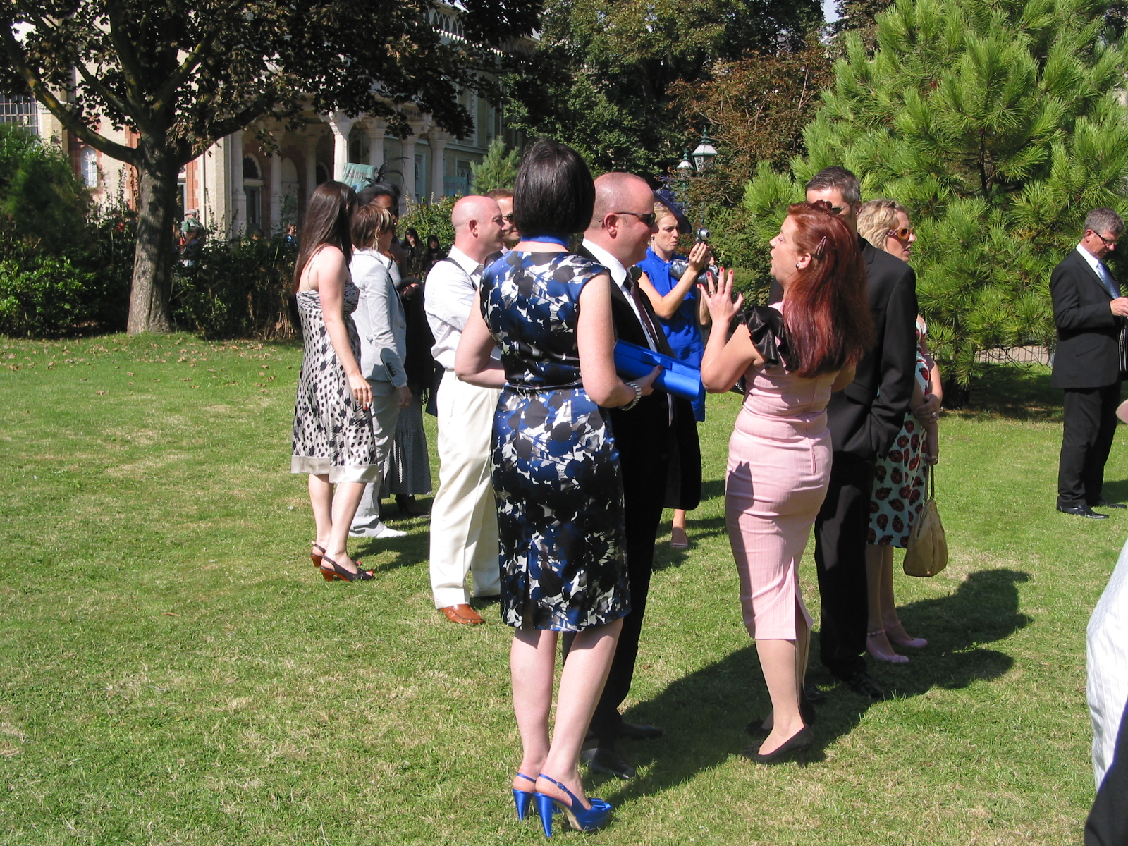 several people are standing in a grass area