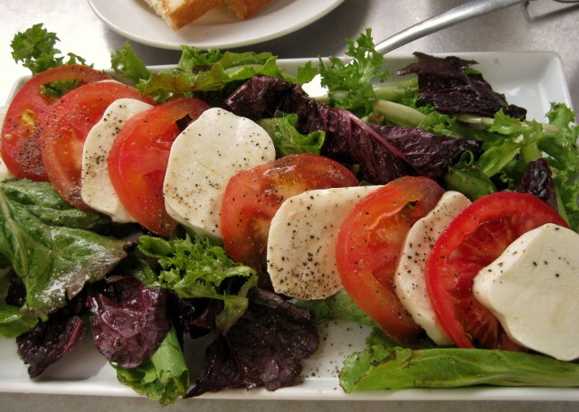 a salad is arranged in groups on a plate