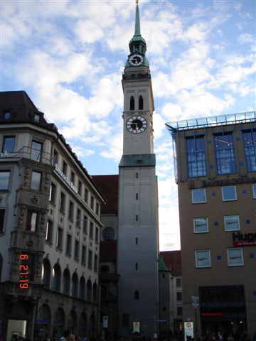 a tower clock in the center of an old european town