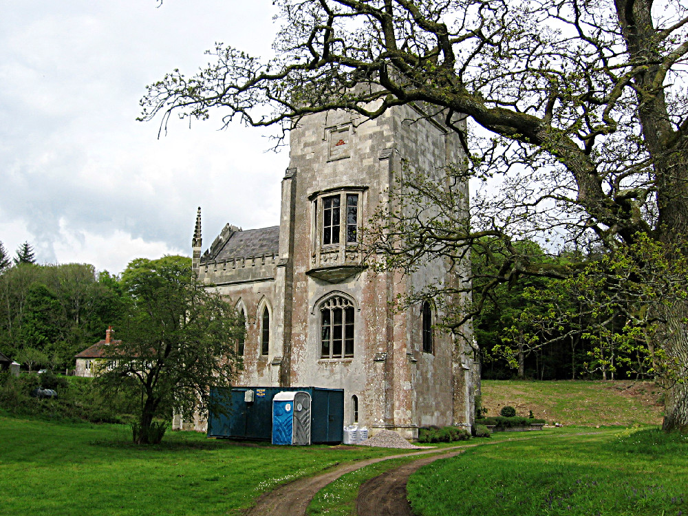 a large tower with many windows is standing out in a field