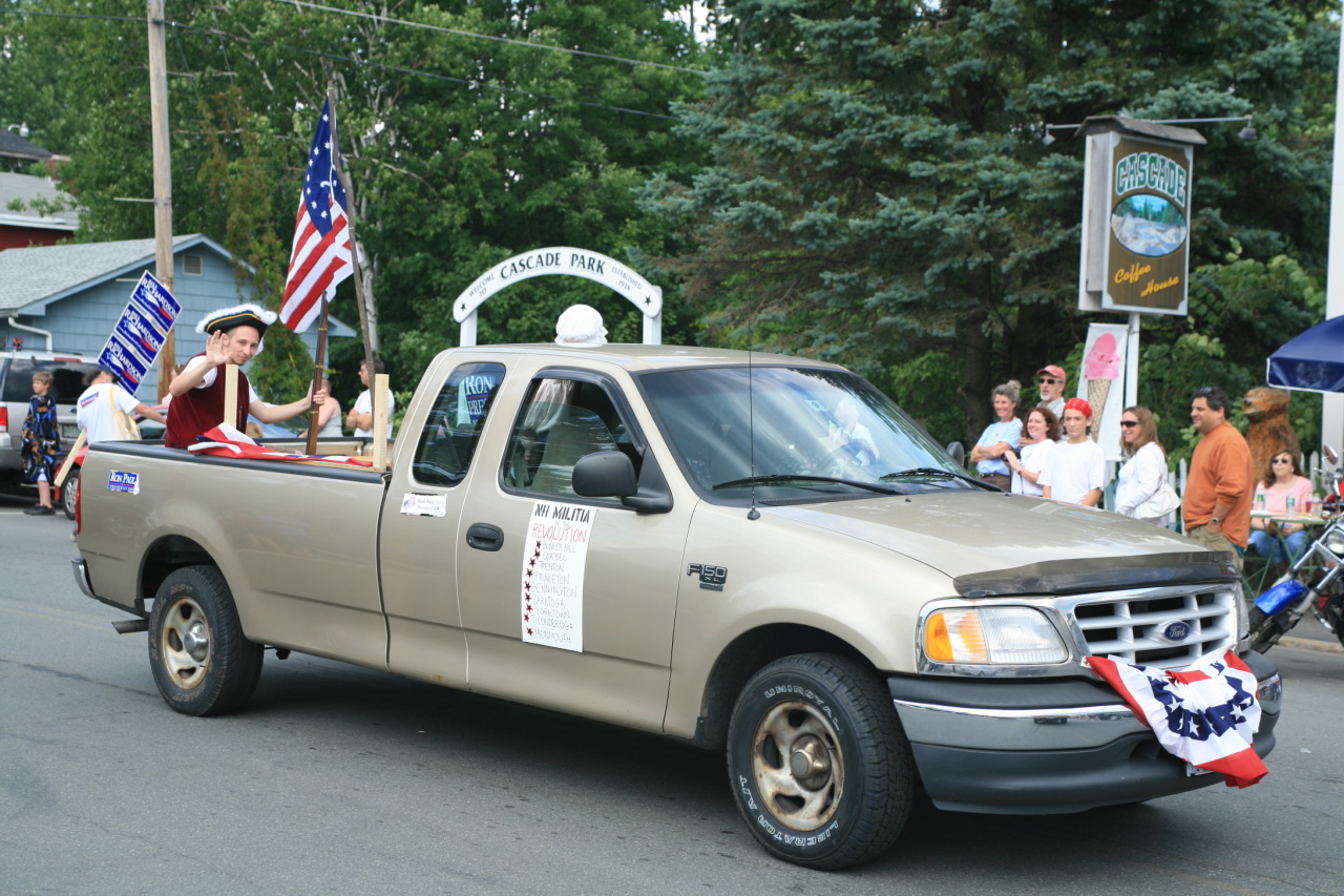 a woman riding in the bed of a pickup truck