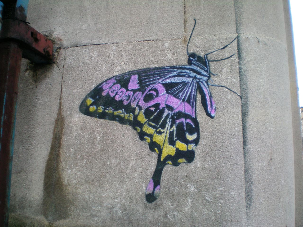a colorful erfly painted on the side of a building