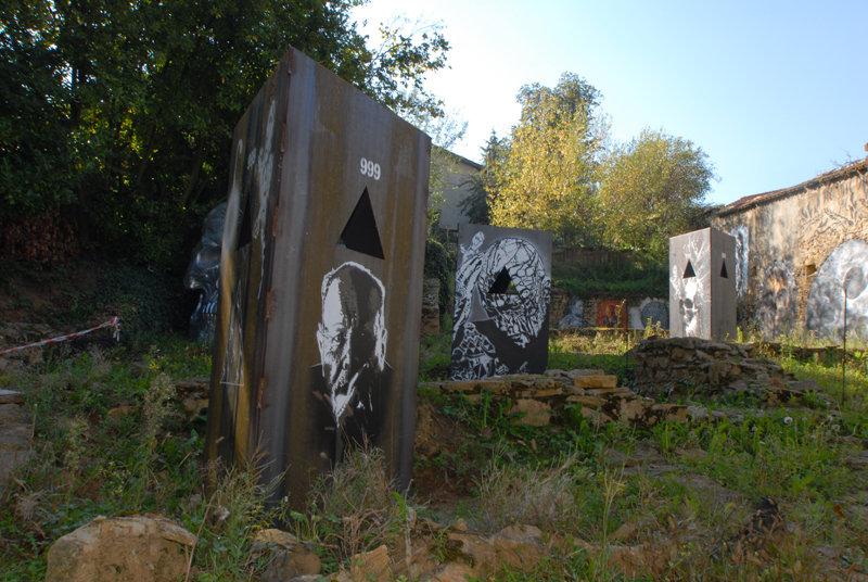 three art pieces sitting in the grass