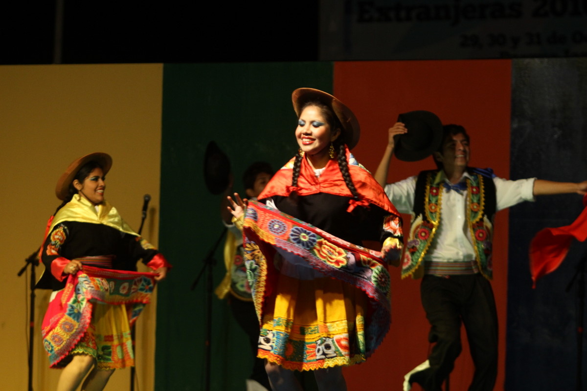 young women in colorful clothing performing an elaborate folk dance