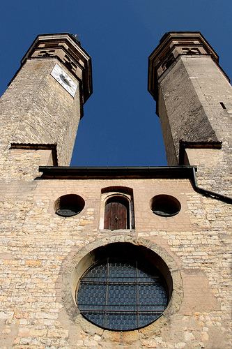 a building with two round windows and some towers