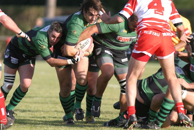 a rugby player holding onto another player during a game