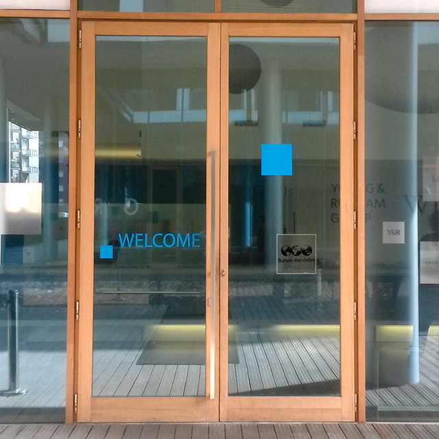 an empty glass building with a welcome sign