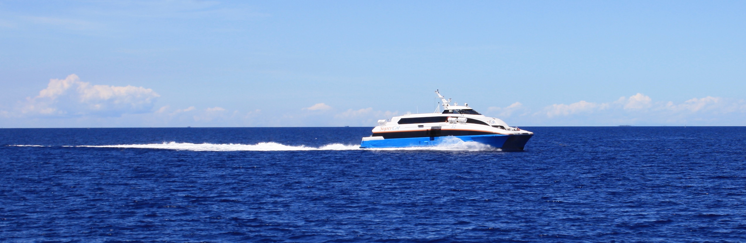 a boat with large propellers is going down the ocean