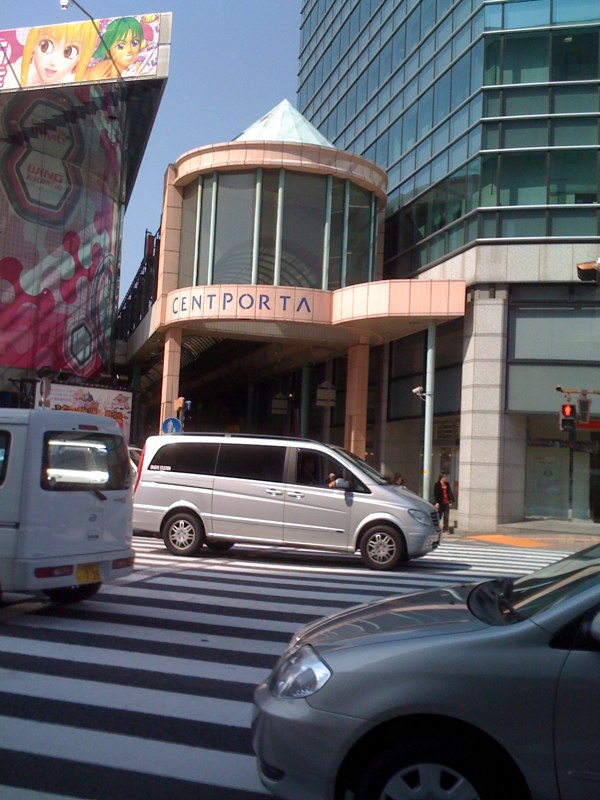 a city intersection with cars and bus on it