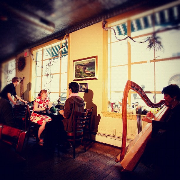 people sit around a table and play music instruments