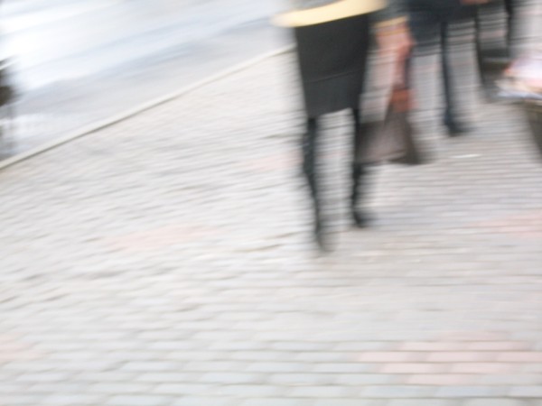 a blurry picture of people walking down the sidewalk