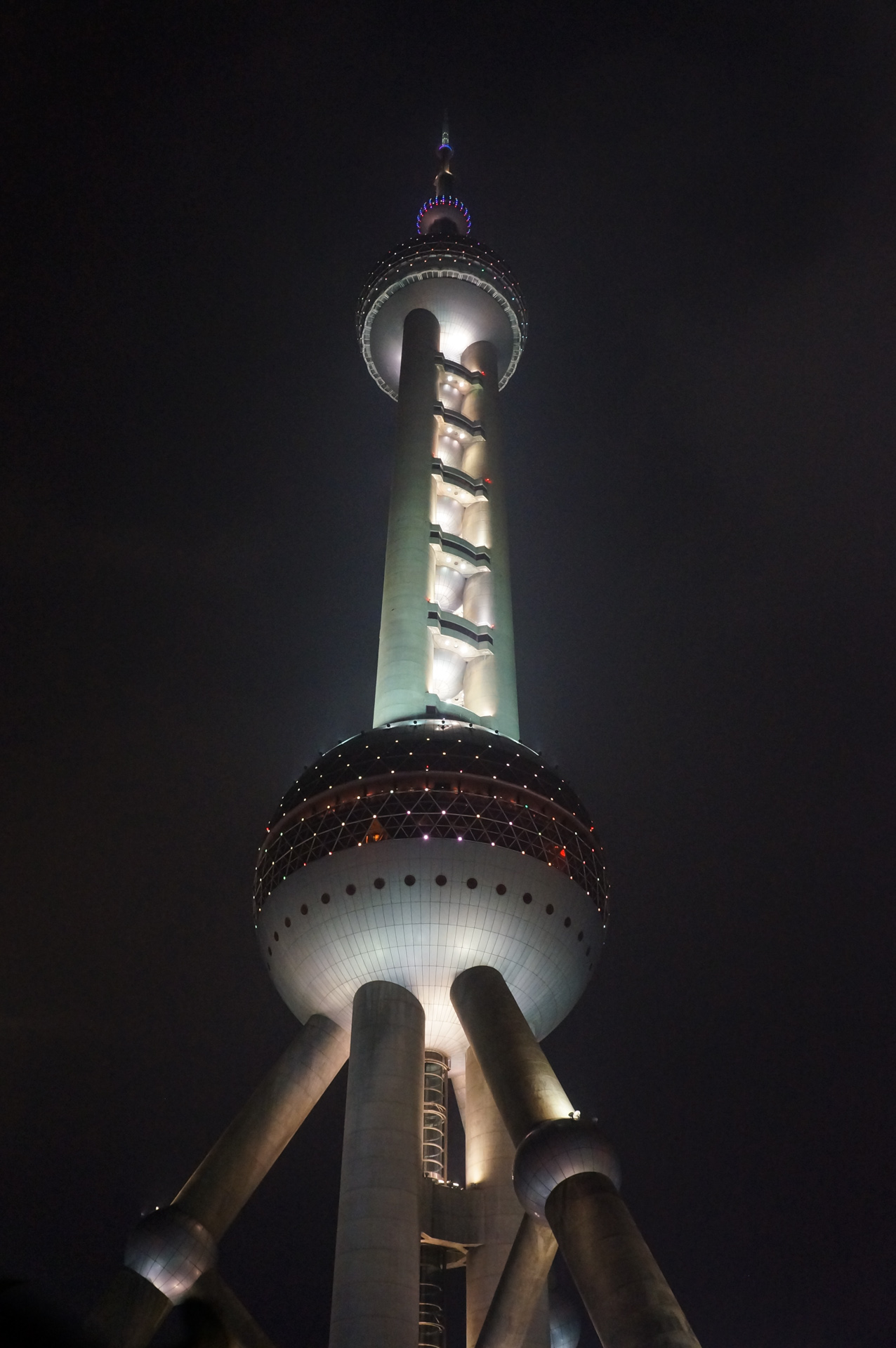 the tall tower at night is lit up with lights