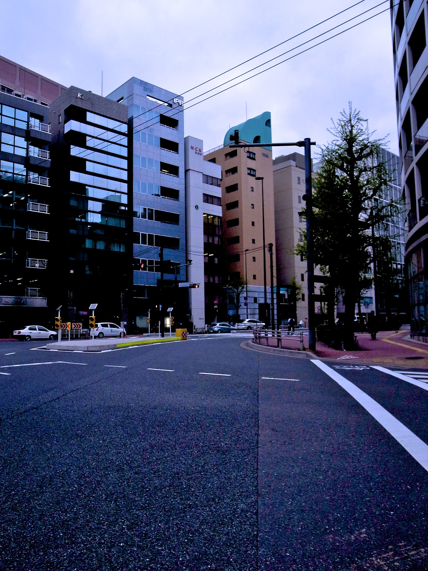 a street with several large buildings behind it