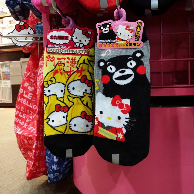 a couple of hello kitty socks hanging on a rack