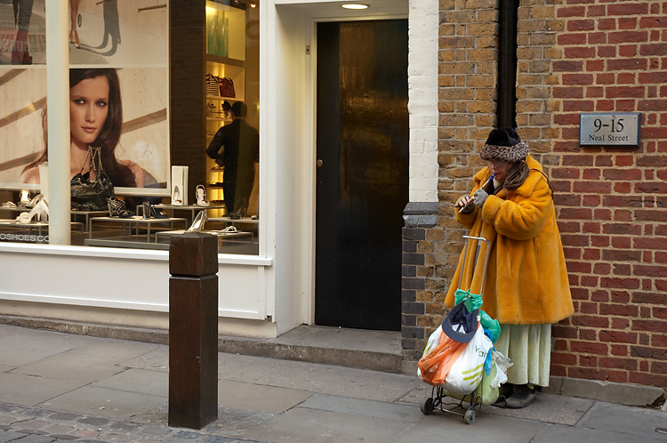 an image of a person standing outside with shopping bags