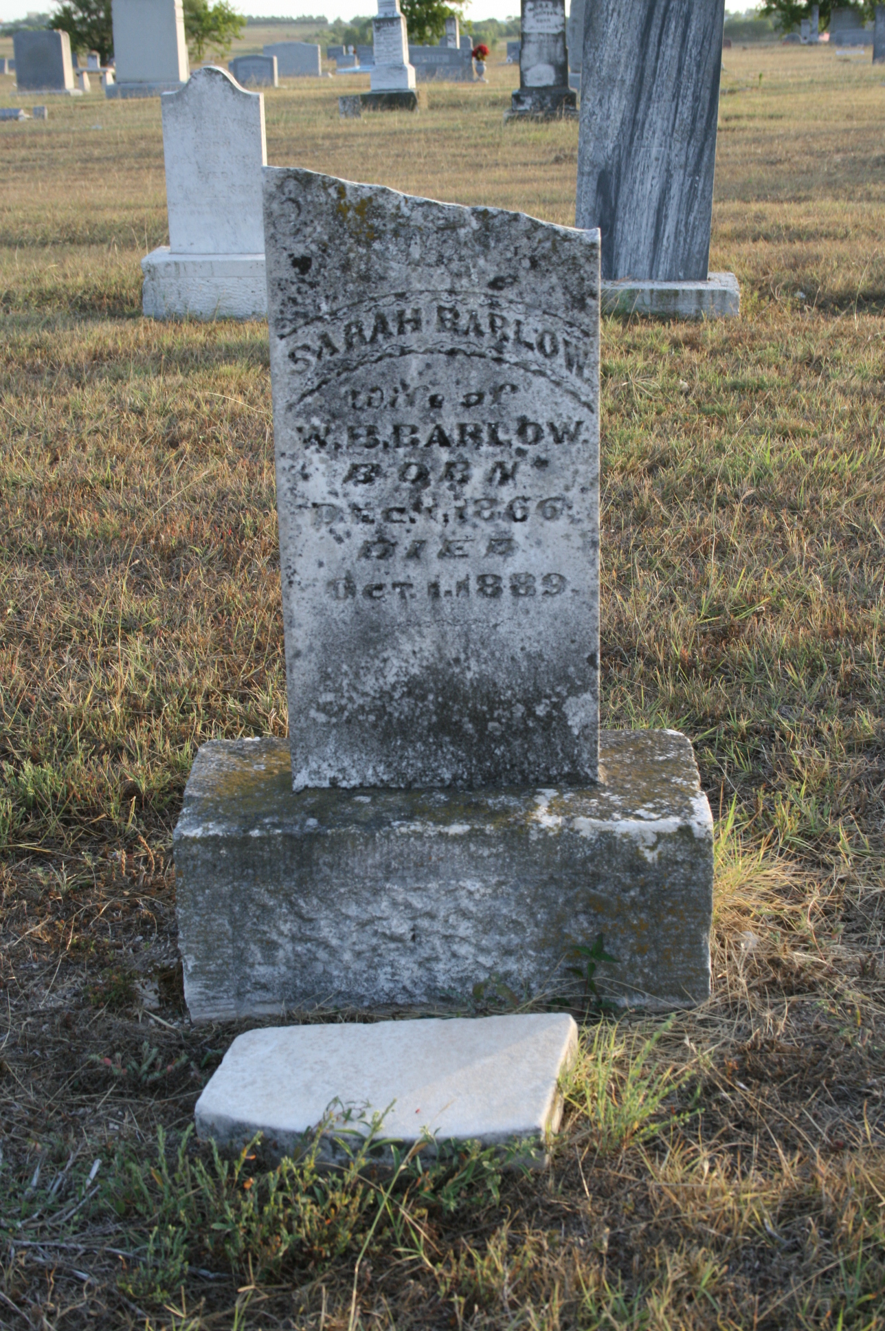 a stone headstone in a grave yard