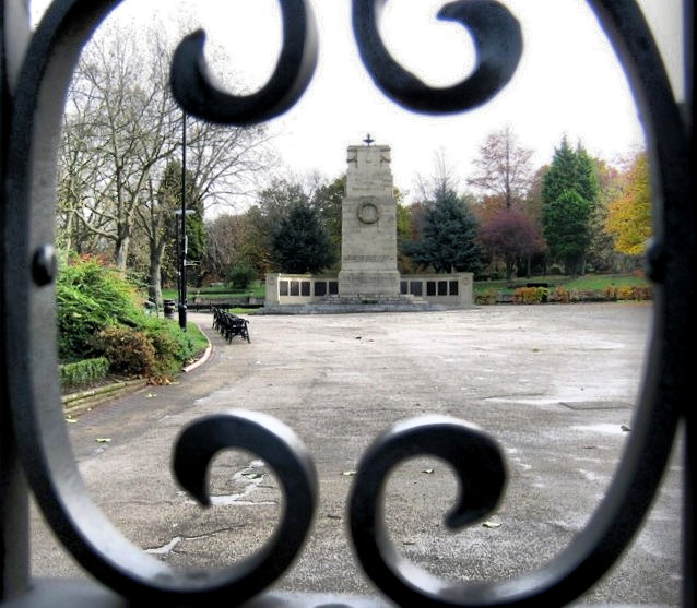 a view of a cemetery through the metal bars