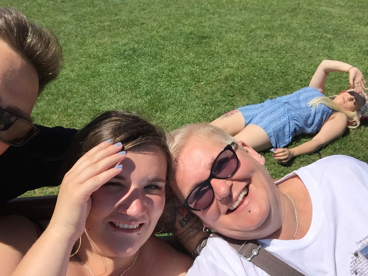 two women are posing for the camera and one is laying down