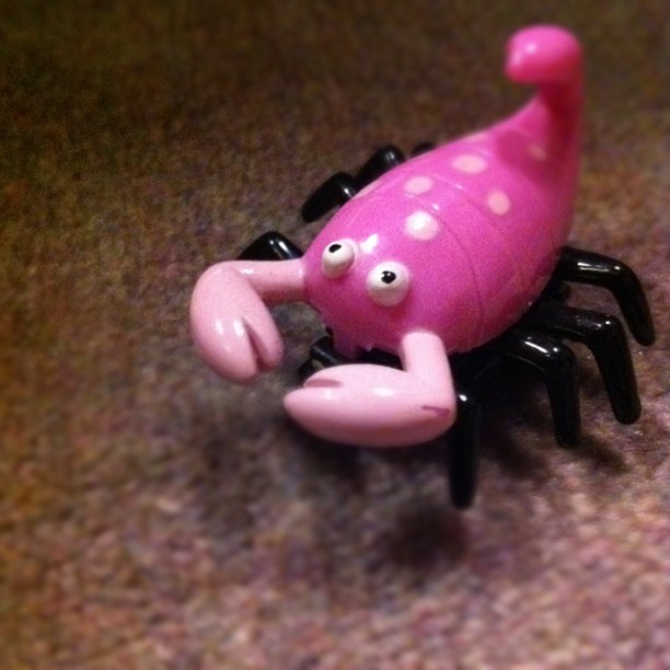 a pink toy with white spots on it