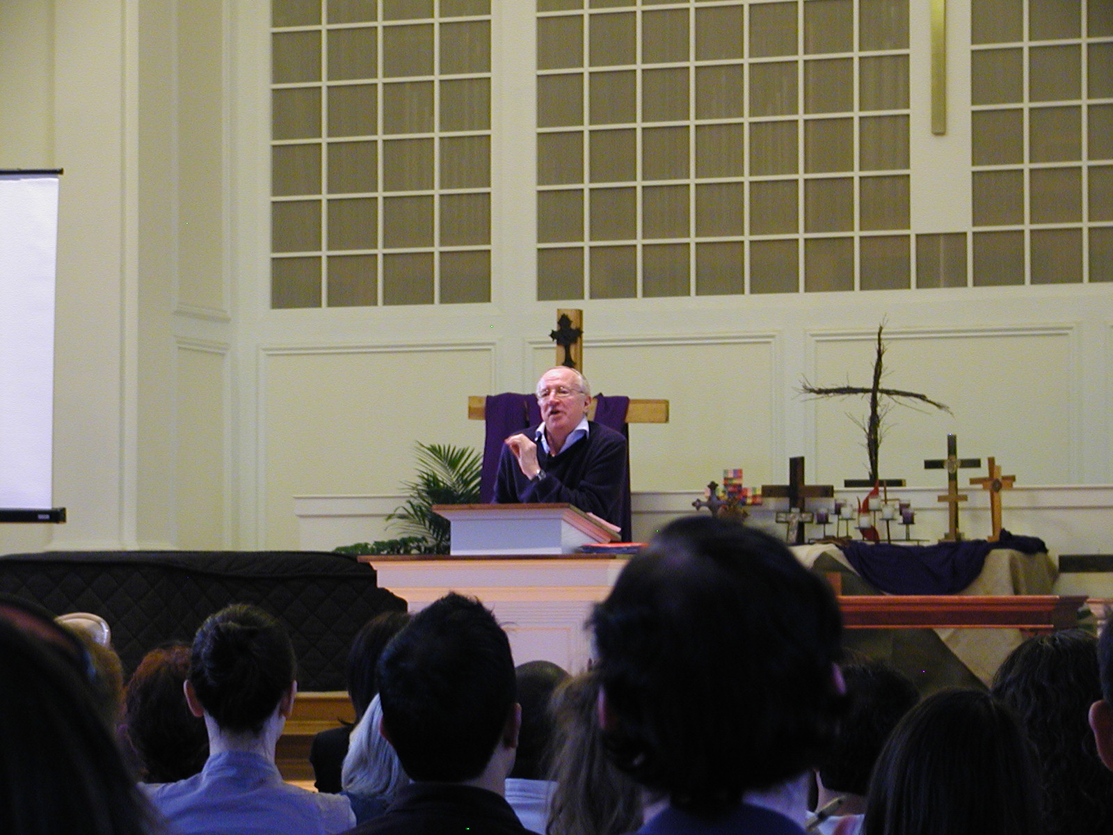 the priest gives his congregation members a presentation