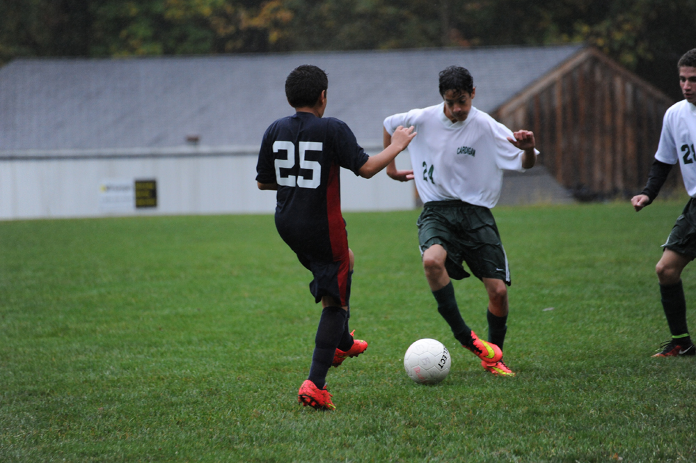 two men are playing soccer in the field