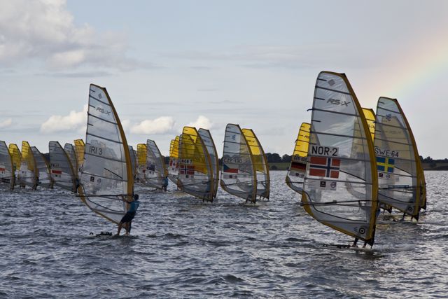 wind surf boarders racing in calm blue water