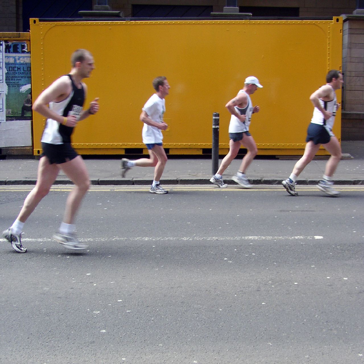 a line of people running together on a street