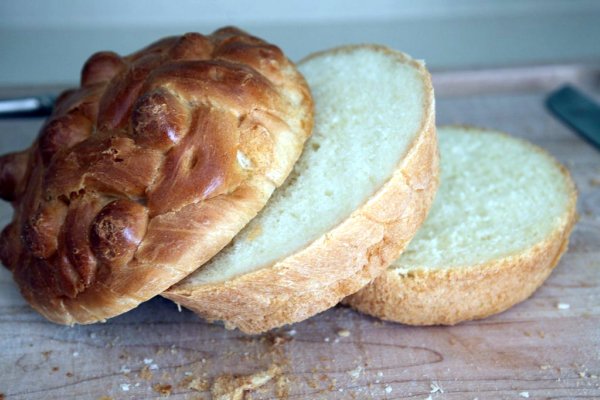 two loaves of bread sitting on top of a  board