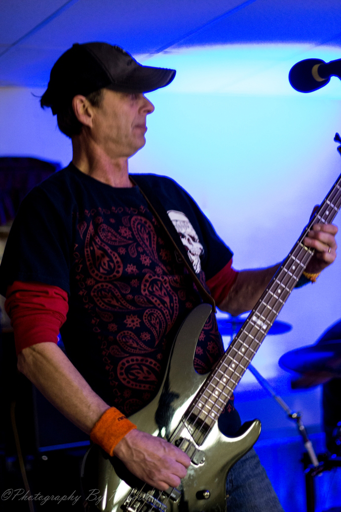 a man holding a guitar in front of microphone