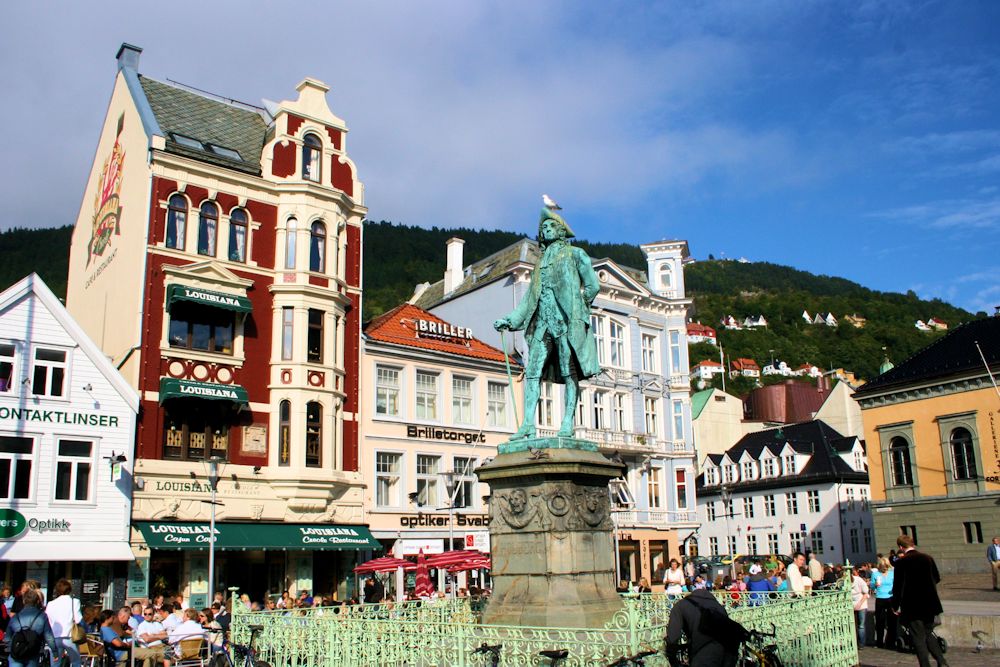 there are people walking and riding in the city square