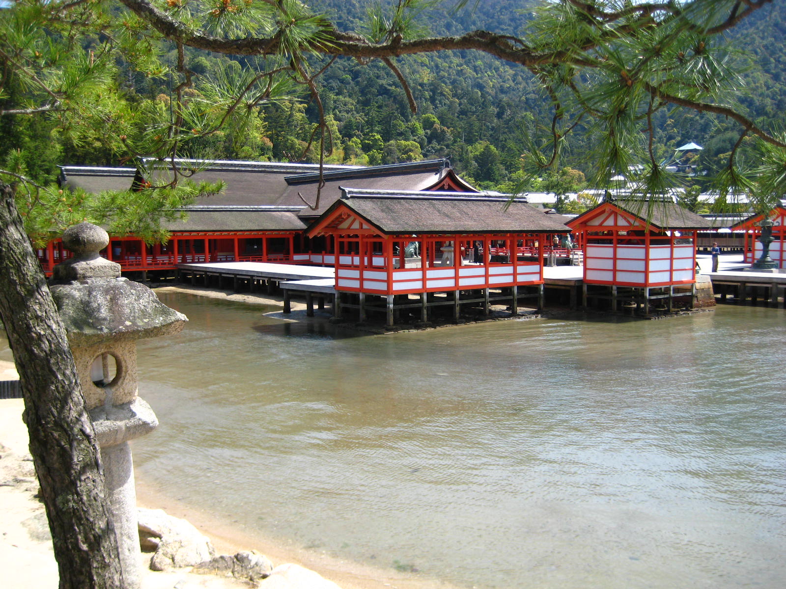 many small red buildings near a body of water