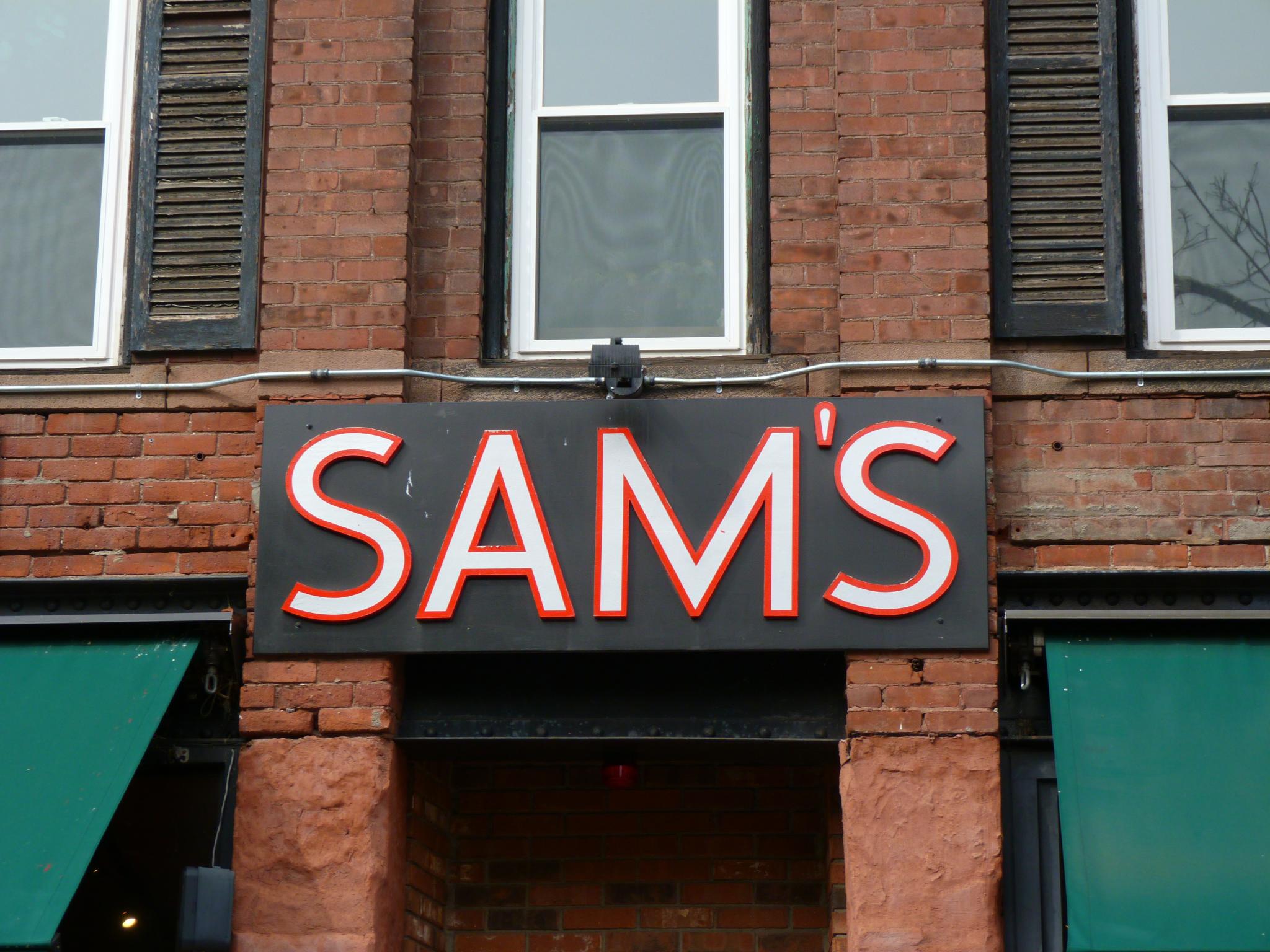 a brick building with the word sam's written below