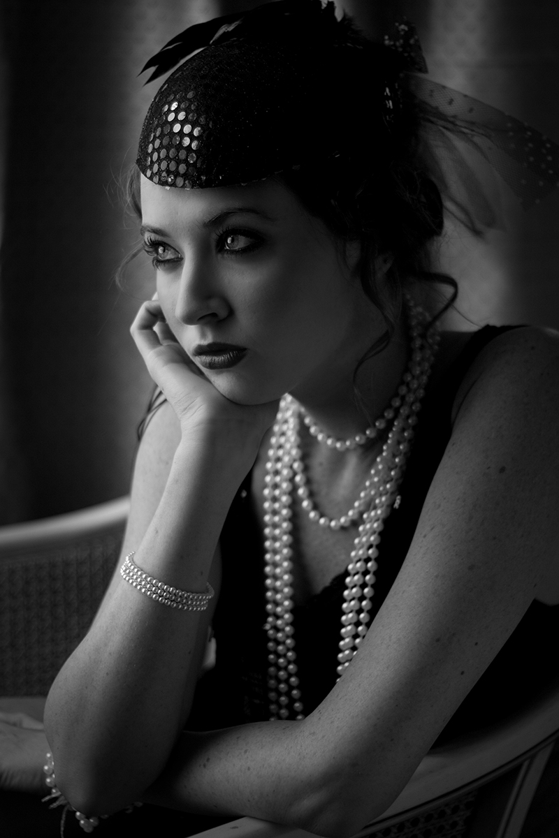 a woman with pearls and a headpiece on
