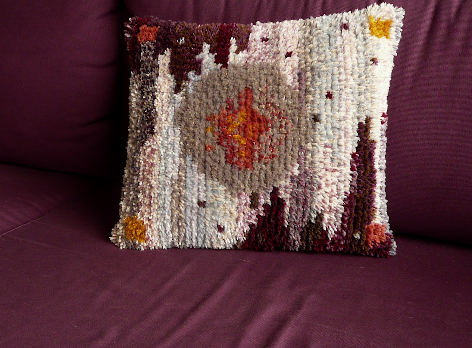 a pillow with red and yellow flowers on it