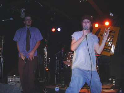two men with microphones in hand on a stage
