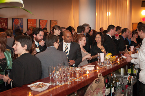 a crowd of people at an event eating and drinking