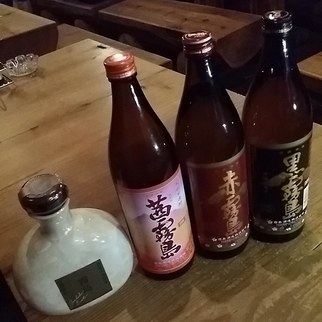 three bottles are placed on a table