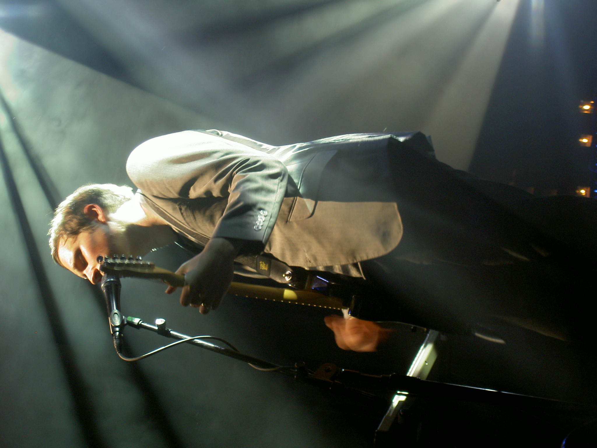 a man bending over on a stage with his foot propped up