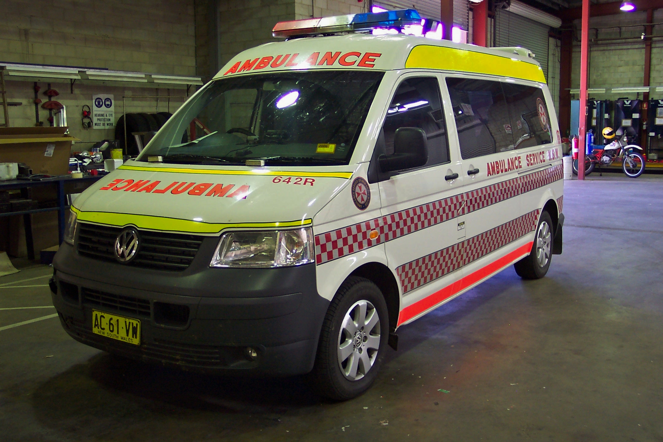 an ambulance van parked in a lot with a yellow stripe