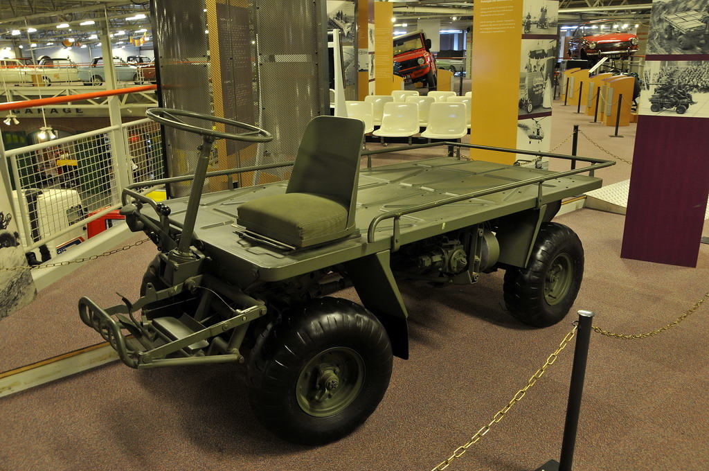 a green utility vehicle with four wheeler attached