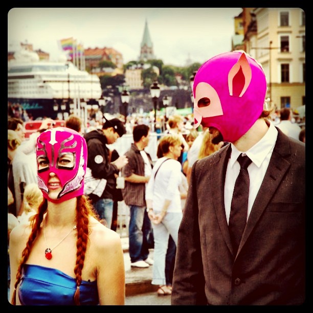 a person wearing a pink mask and another persons in a suit