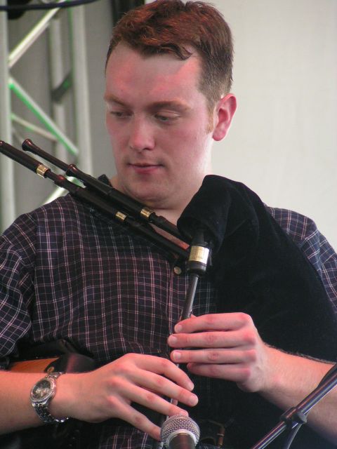 the man is playing the instrument at the event