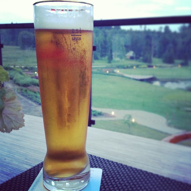 a glass of beer is sitting on top of a table