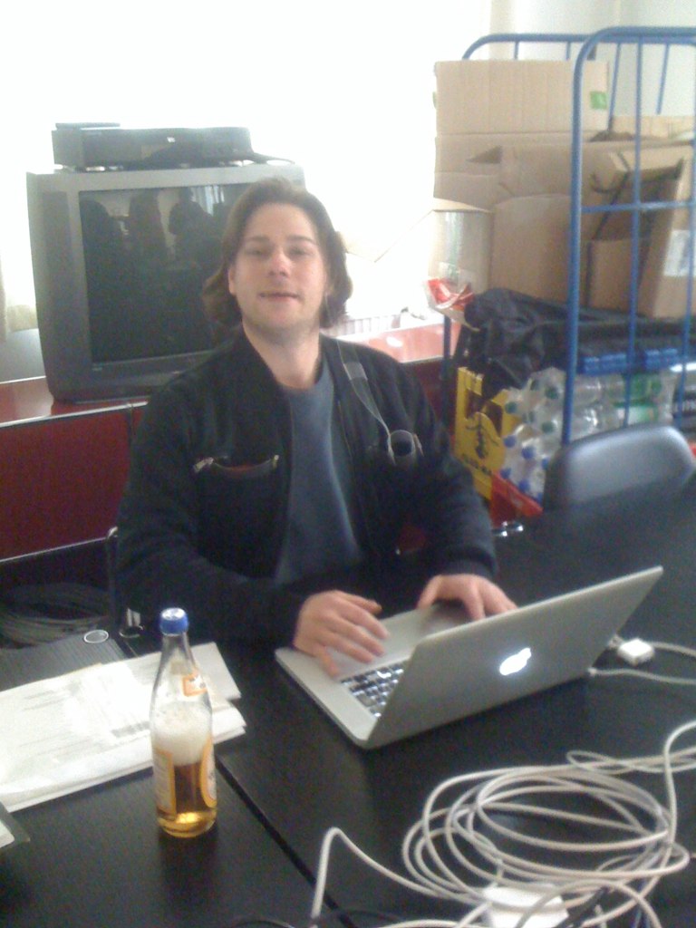 a man sitting at a desk on his laptop