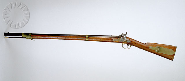 an antique rifle with engraved decals on it
