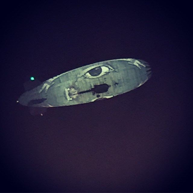 an old blimf is flying in the sky at night